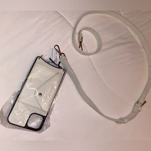 Bandolier IPhone 14 Plus case with strap. Small stain on strap but may come off